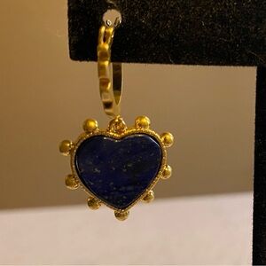 Tory Burch blue lapis heart drops hanging from huggie hoops.